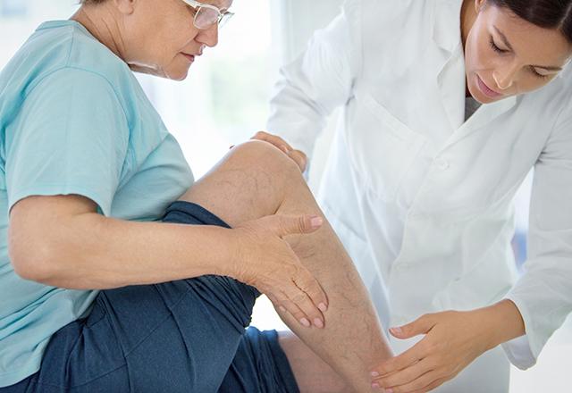 doctor holding patient leg