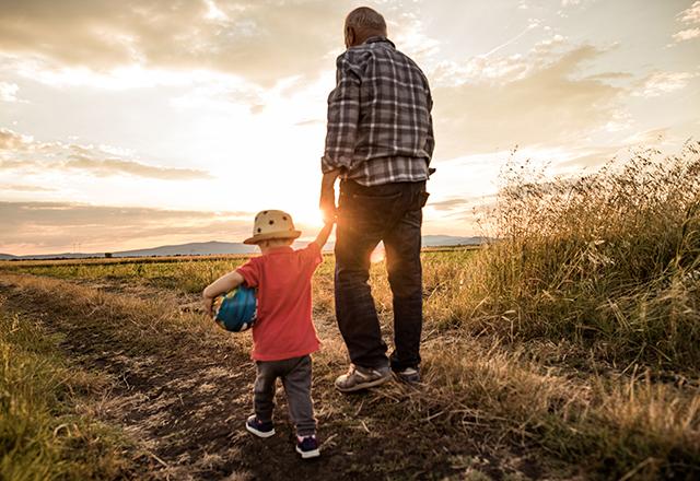 heart and vascular institute - back of grandfather walking with grandson