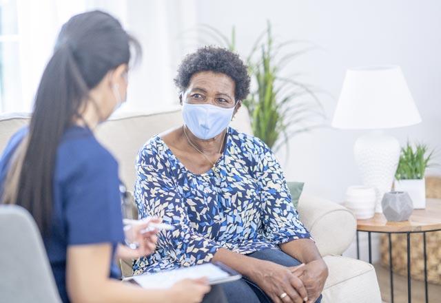 Physician with patient in home