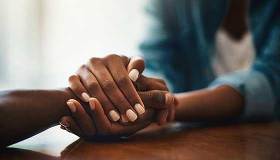 holding hands on table