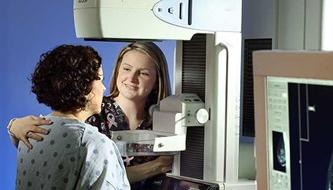 A woman gets a mammogram.