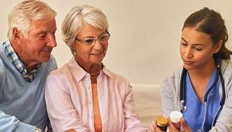 man and woman reviewing medicine with nurse