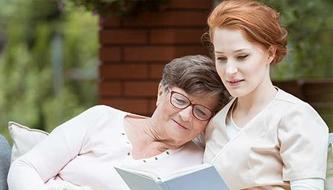 woman reading with caregiver