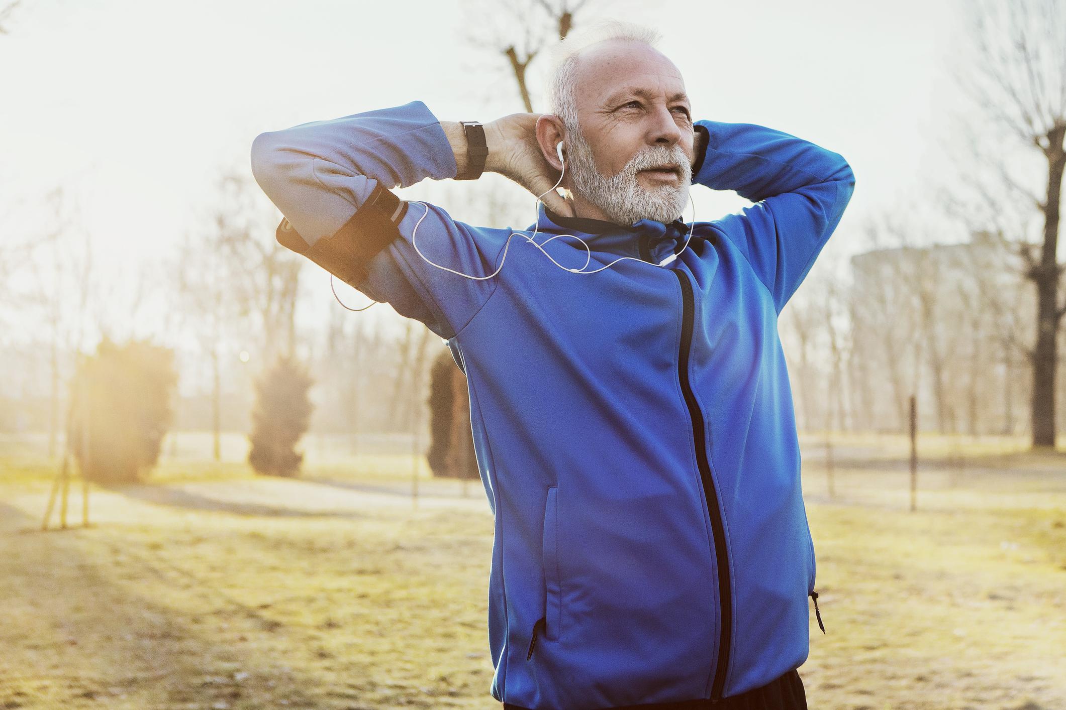 active senior male stretching outside