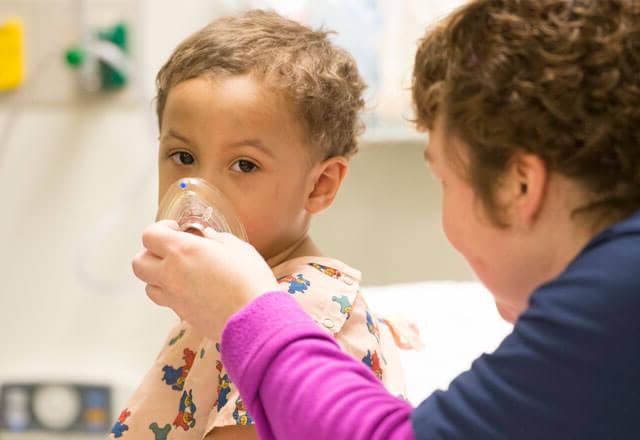 young girl with a general anesthesia mask over her face