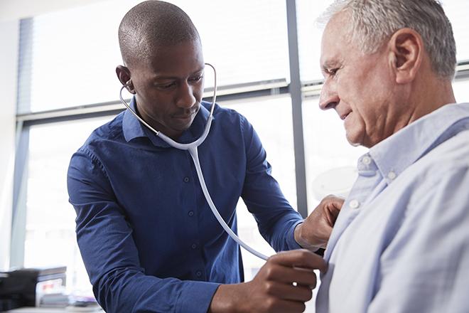 Doctor examines patient with stethoscope