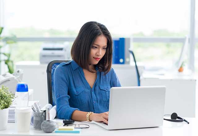 Woman typing on laptop