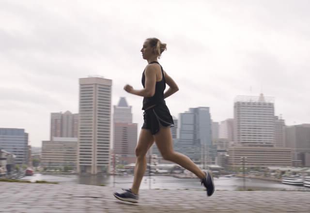 Grace jogging with the city in the background.