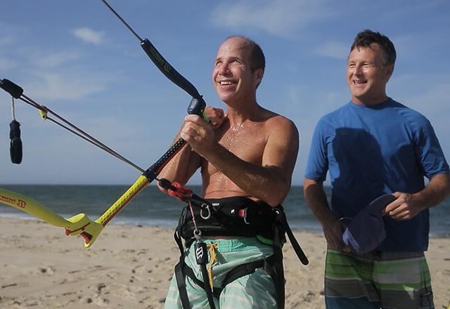 Scott holding on to a paragliding handle bar.