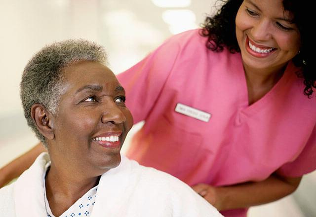 nurse smiling with elderly patient