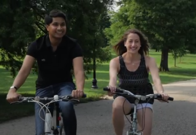 two people riding a bike through patterson park in baltimore