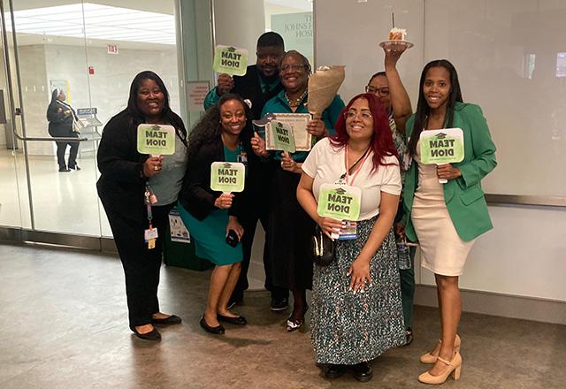 Leaders posing with Team Leon signs