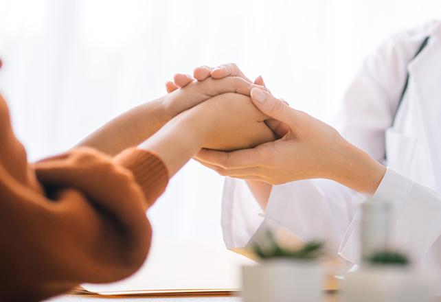 doctor holding patient's hand