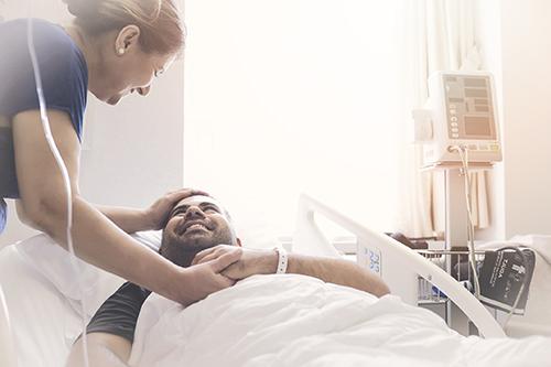 man smiling in hospital bed