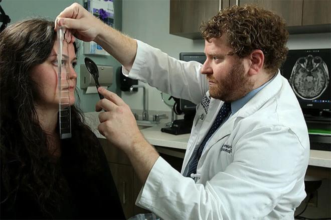 Dr. Colin Kane with a patient during an exam.