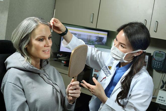 Dr. Li works examines a patient at the Wilmer Eye Institute